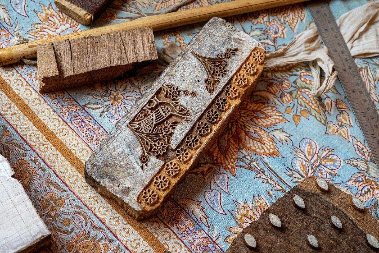 Illustrative image: wooden printing blocks resting on block printed fabric