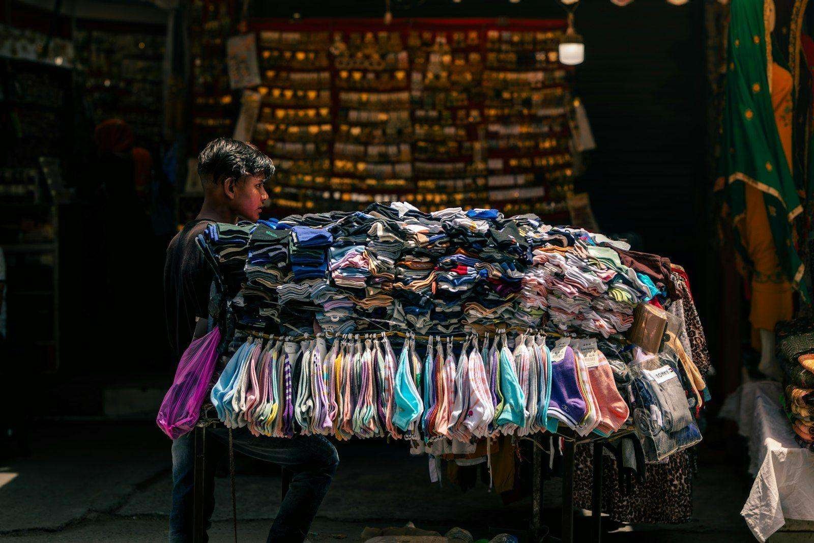 Illustrative image: large bundle of colourful textiles at a market