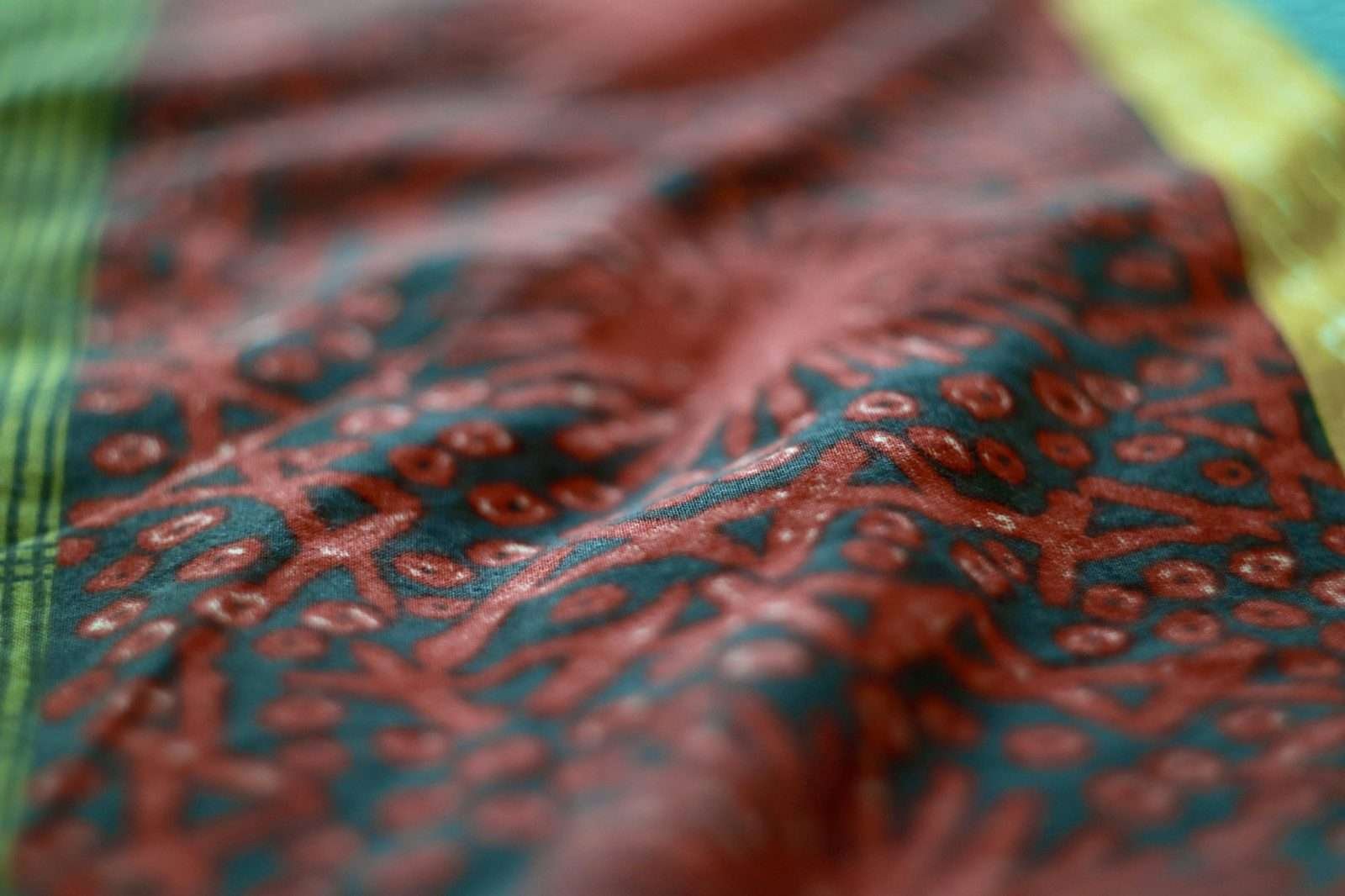 Illustrative image: close-up of red and teal fabric with small dot motifs