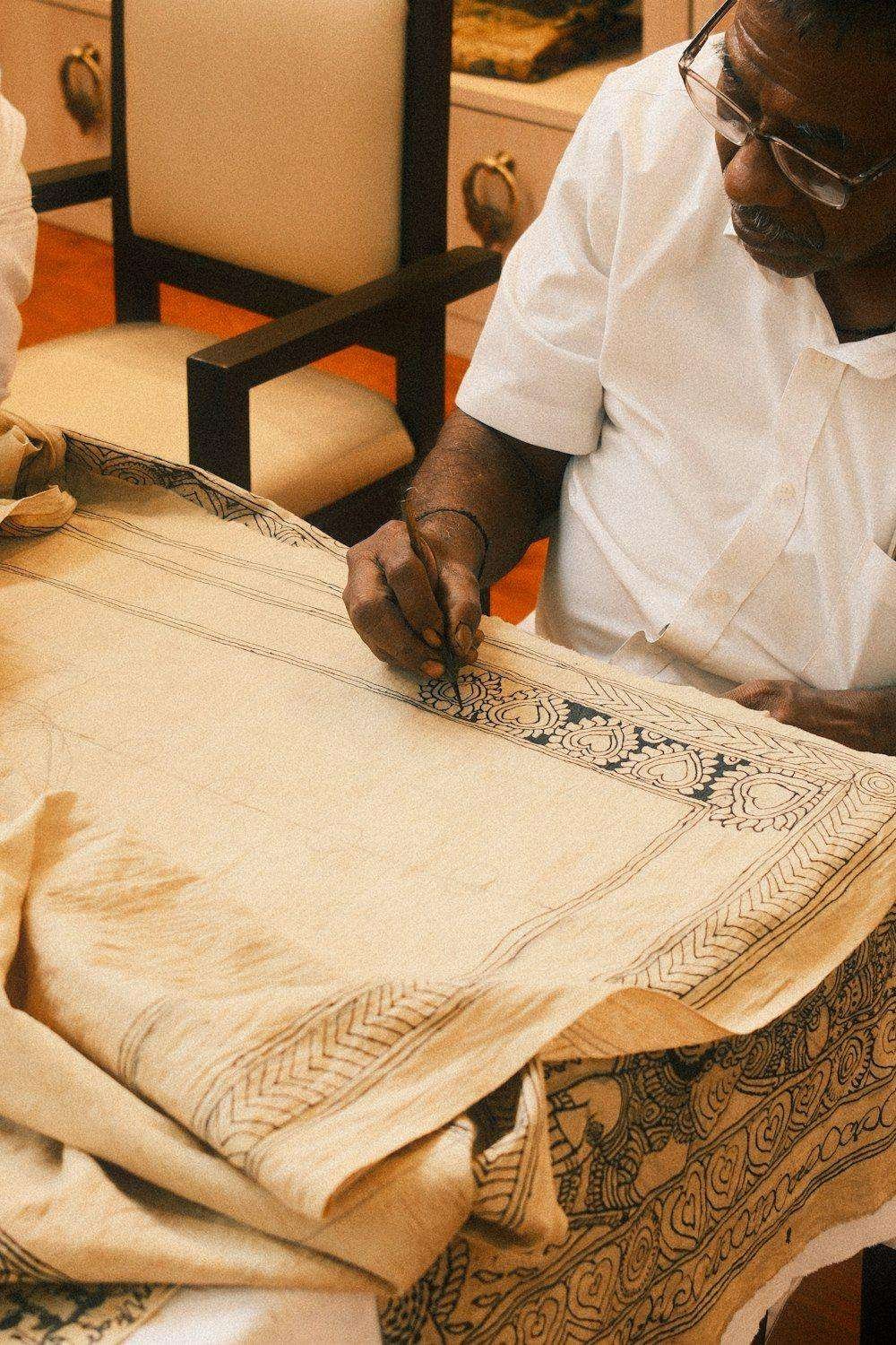Illustrative image: artisan hand painting a design on fabric