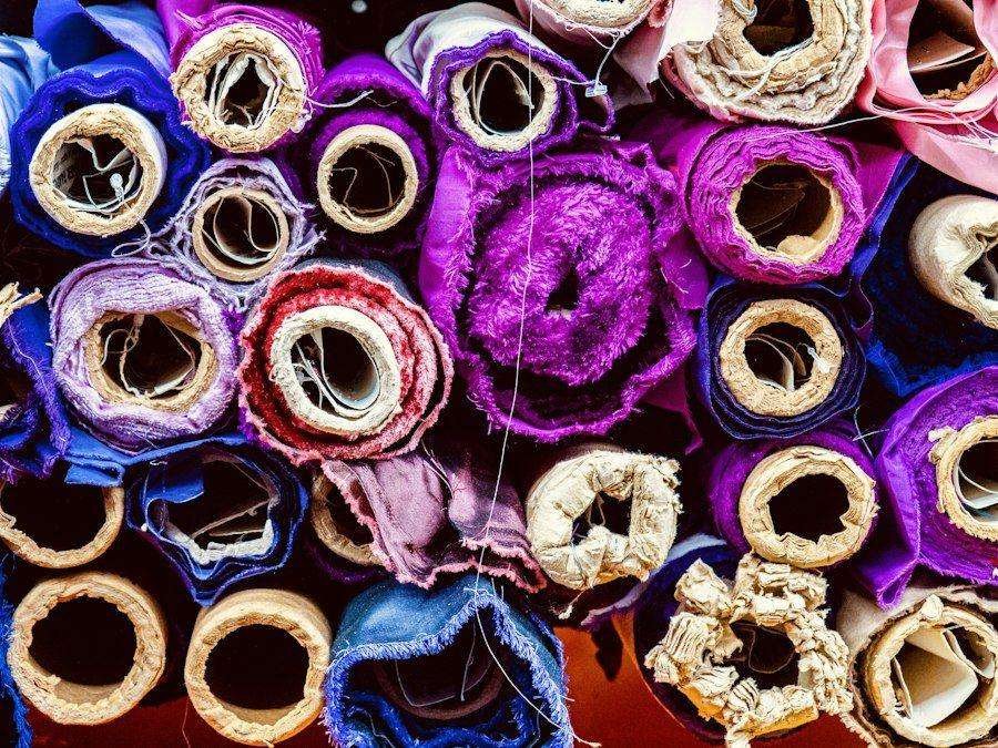 Illustrative image: rolls of colourful fabric at a market