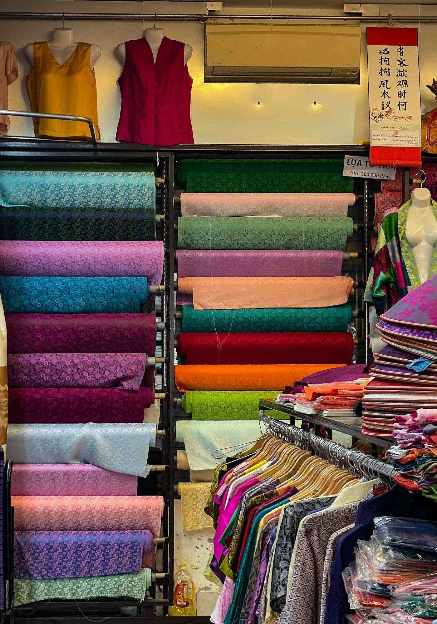 Illustrative image: fabric shop shelves stacked with colourful rolls