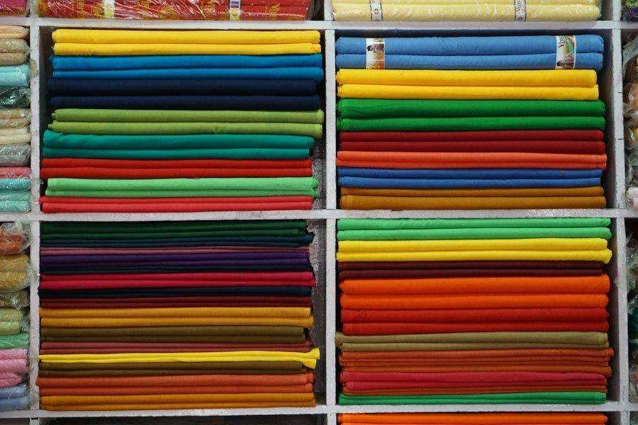 Illustrative image: shelves stacked with colourful fabric