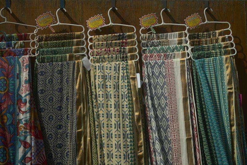 Illustrative image: patterned fabrics displayed on hangers