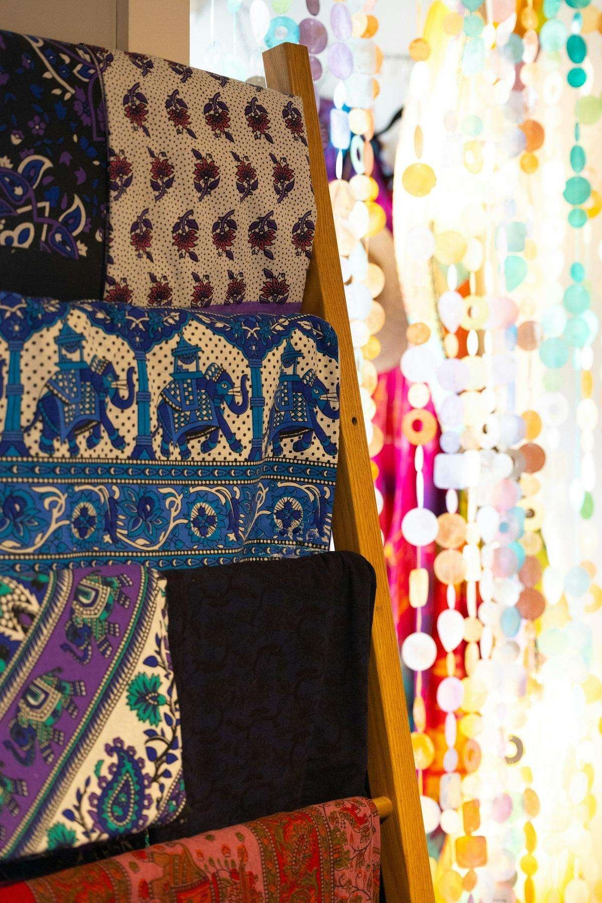 Illustrative image: patterned fabrics draped on a wooden ladder