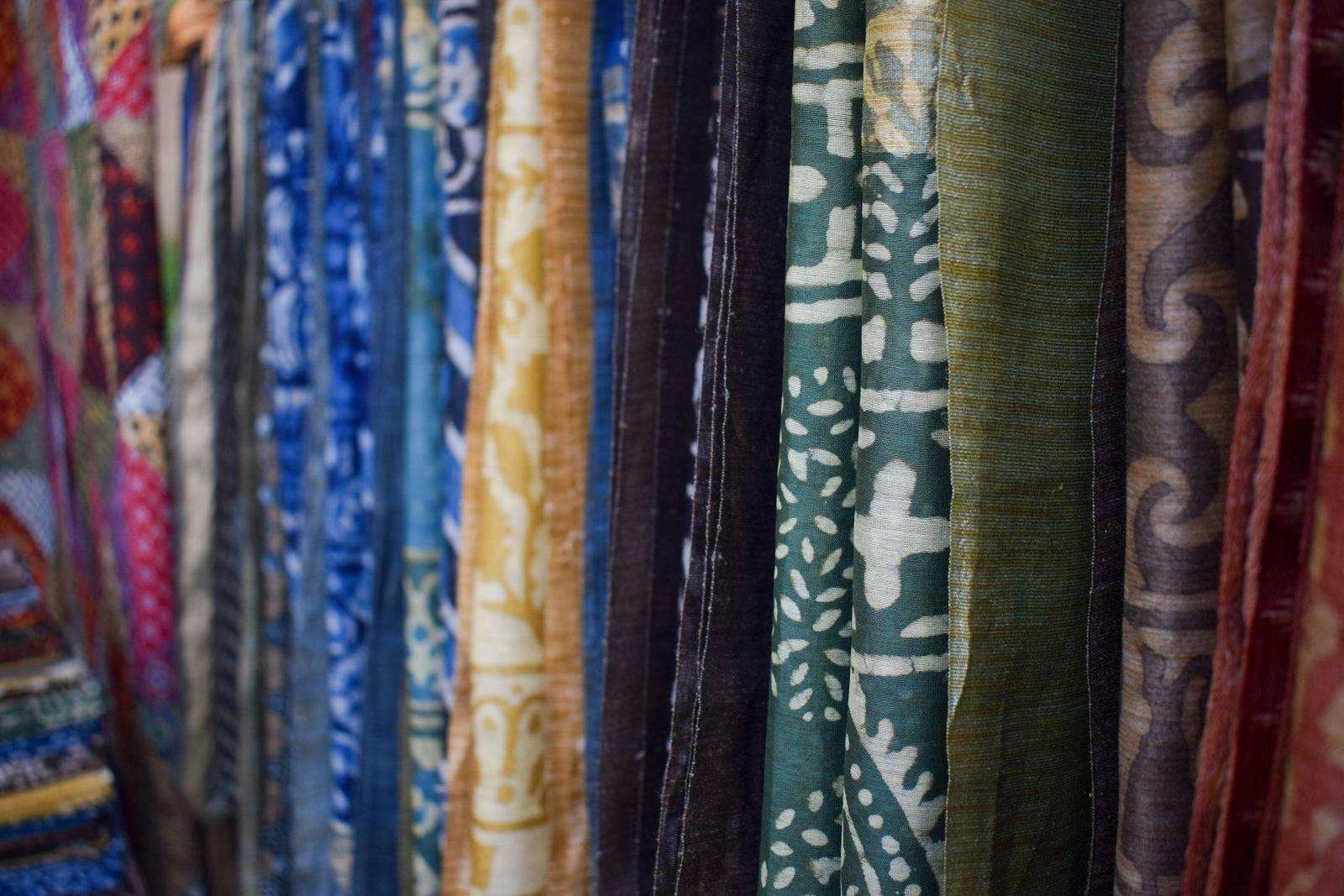 Illustrative image: rows of patterned fabrics hanging on display