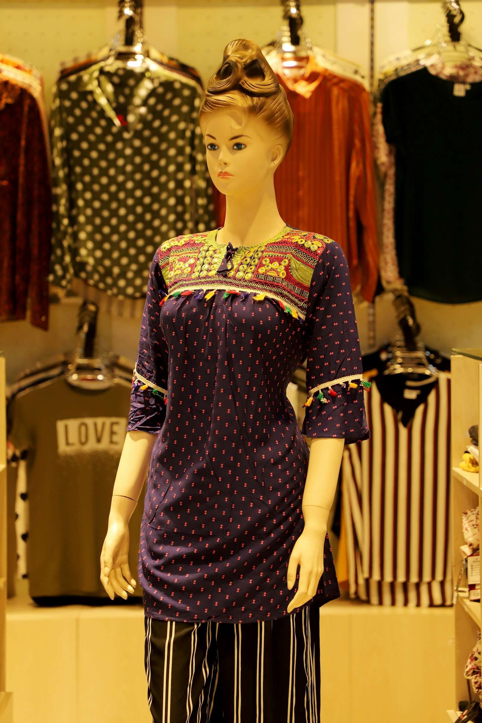 Illustrative image: purple printed cotton kurti on a mannequin
