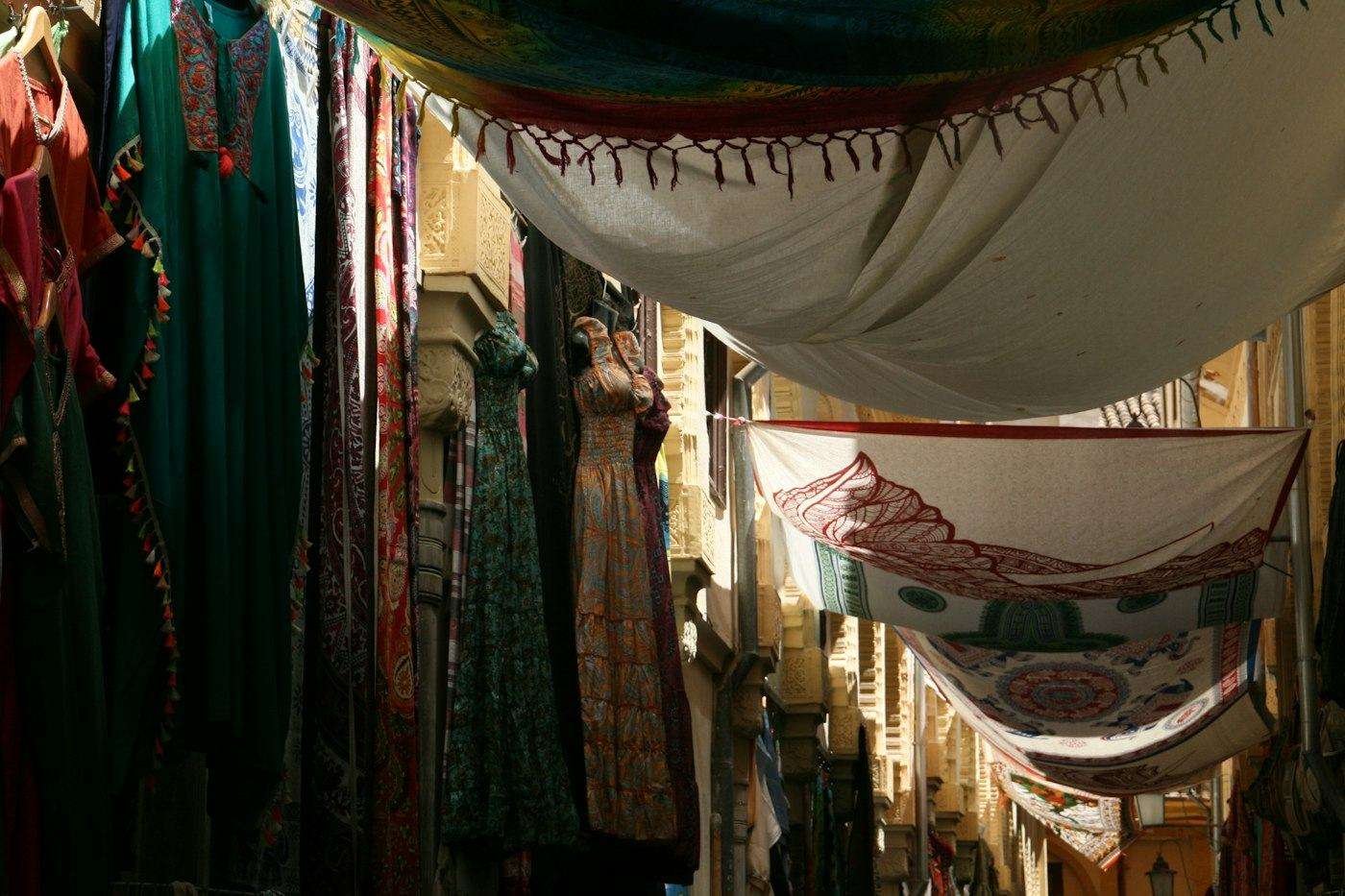 Illustrative image: market alley hung with fabrics