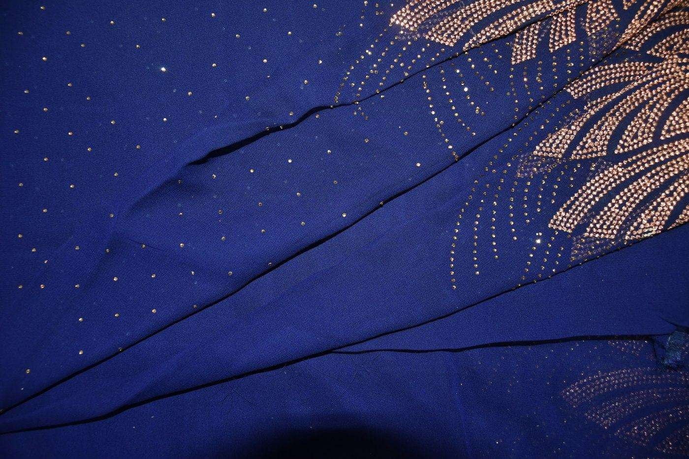 Illustrative image: close-up of a blue saree with gold dots
