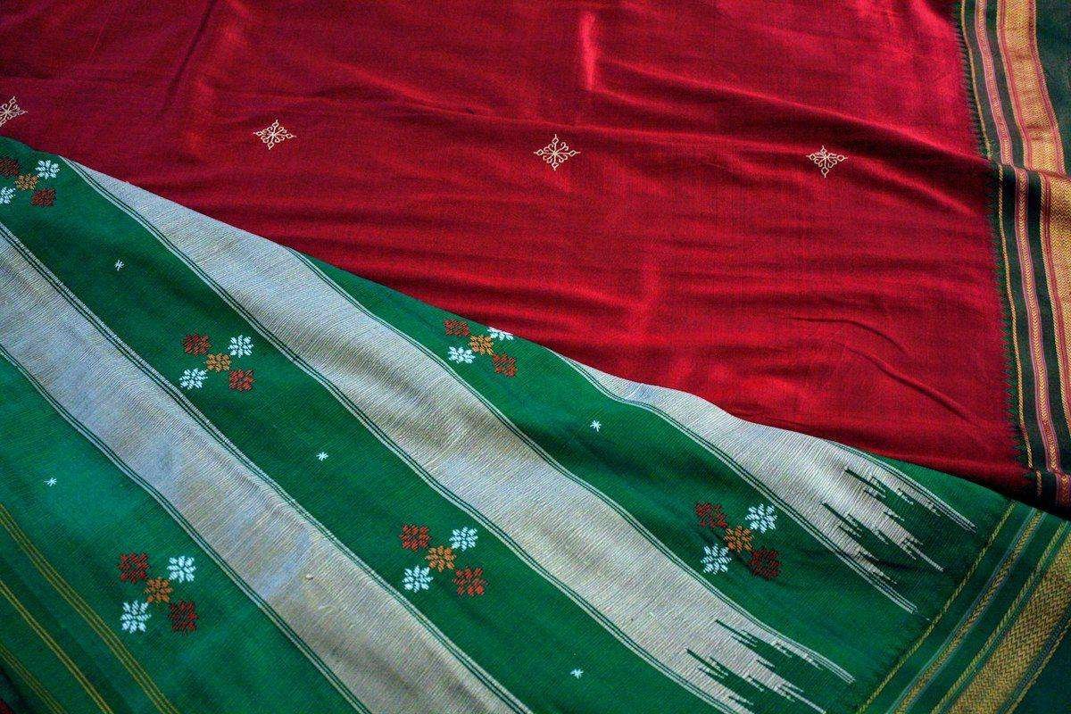 Illustrative image: close-up of a red and green saree with motifs