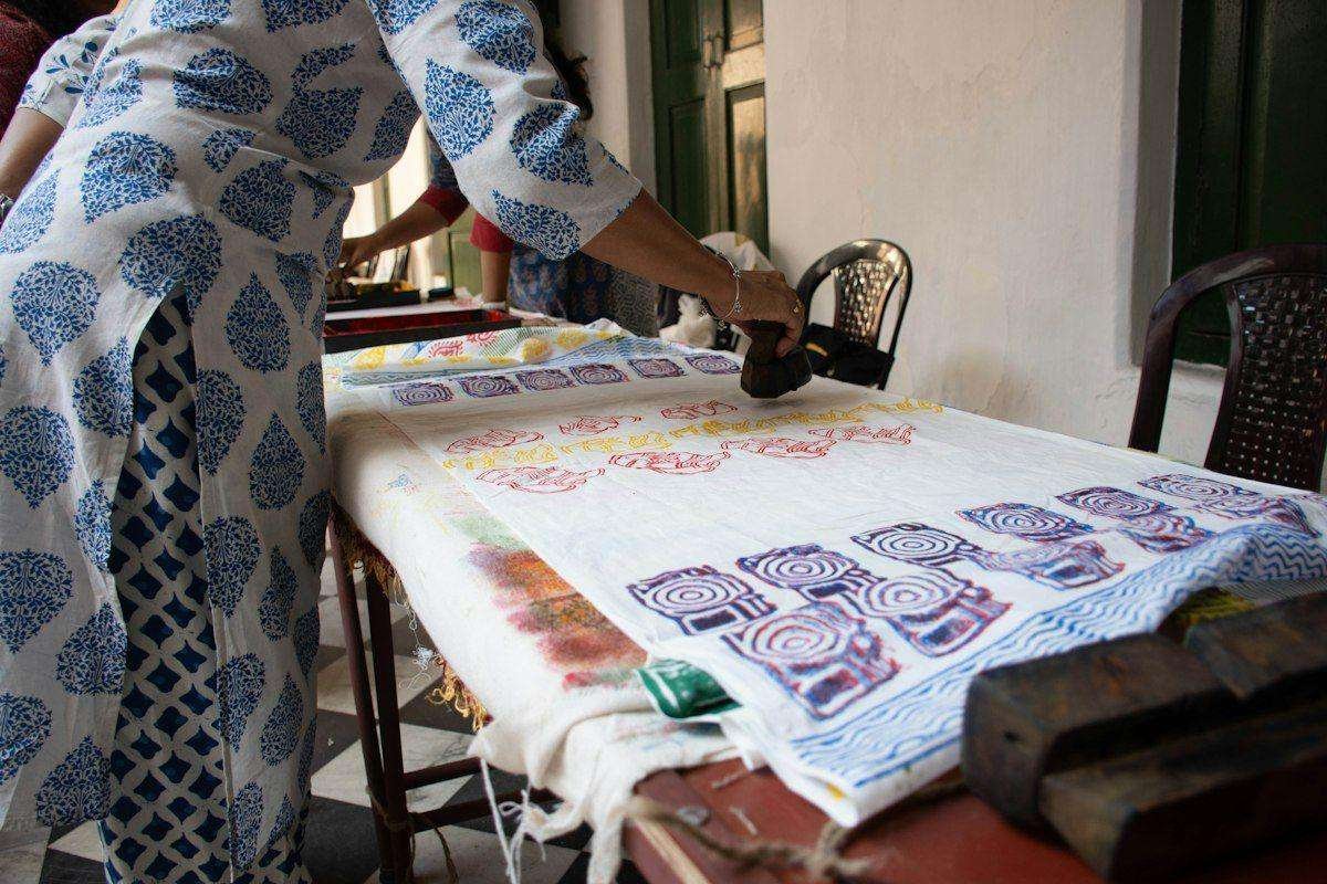 Illustrative image: fabric being block printed on a work table