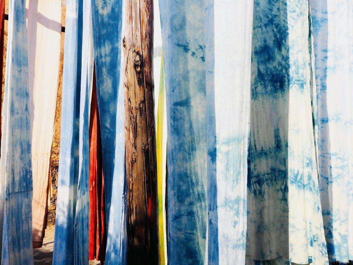 Illustrative image: tie-dyed fabrics hanging in the sun